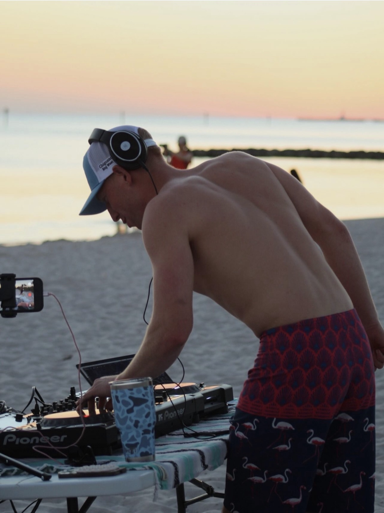 Will Andrews DJing on the beach at sunset